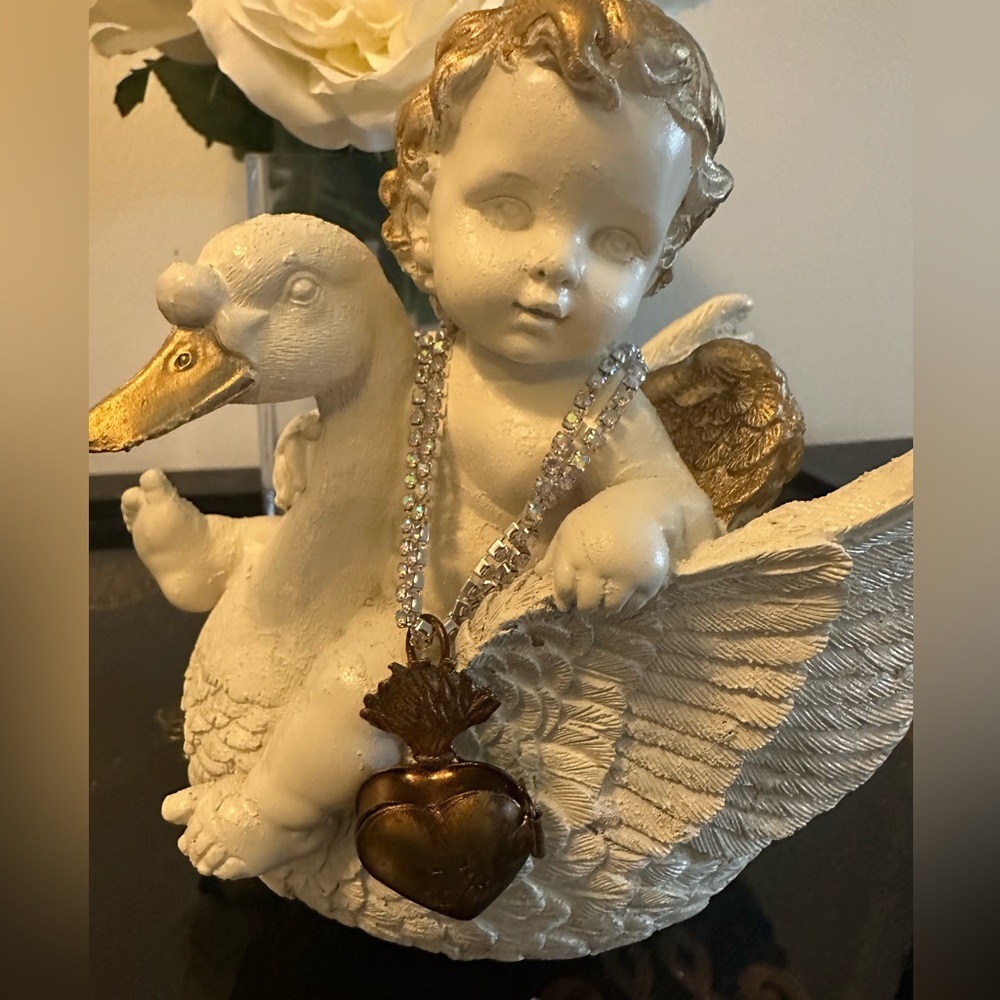 Cherub riding swan